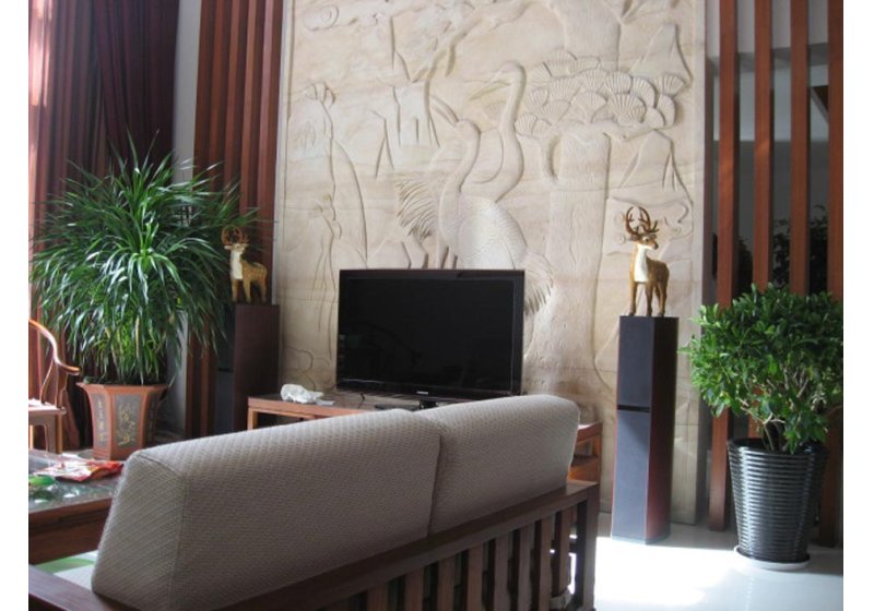 电视背景墙运用石材雕塑，代表吉祥如意的仙鹤栩栩如生，成为客厅的亮点。
