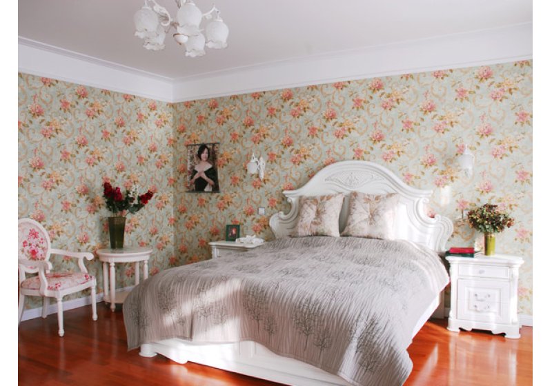 主卧：墙面随意的卷草壁纸和白色的铁艺花灯上下呼应，相互映衬，配以法式白色木床，处处诠释着浪漫的含义。